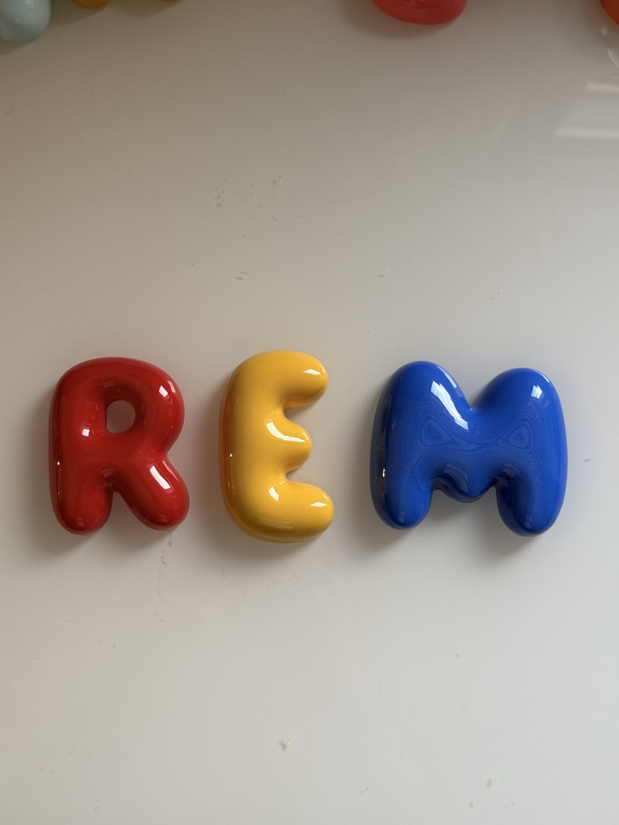 REM personalised bubble letters in red, gold and blue